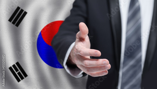 Korean business, politics, cooperation and travel concept. Hand on flag of Korea background.