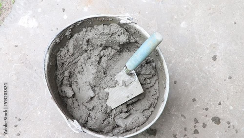 Mixing of concrete mortar.The builder prepares the cement mortar using a construction trowel.Plaster mortar in a bucket.