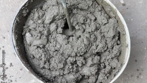 Mixing of concrete mortar.The builder prepares the cement mortar using a construction mixer.Plaster mortar in a bucket.
