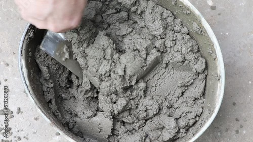 Mixing of concrete mortar.The builder prepares the cement mortar using a construction trowel.Plaster mortar in a bucket.