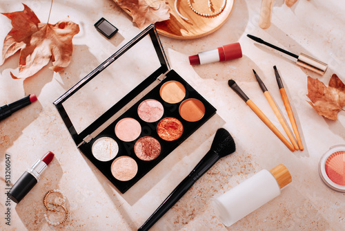 Autumn skincare and autumn makeup concept with beauty products on table