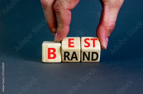 Build your best brand symbol. Concept words Best brand on wooden cubes. Businessman hand. Beautiful grey table grey background. Build your best brand and business concept. Copy space.