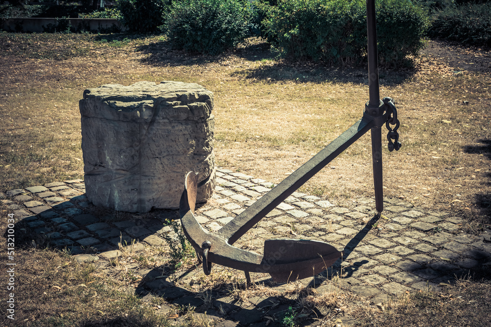 a decorative old anchor in a garden a decorative old anchor in a garden
