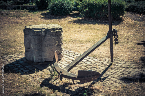 a decorative old anchor in a garden