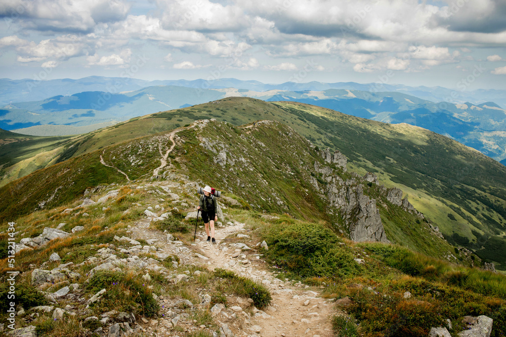 Hiker on the top in Carpathians mountains. Travel sport lifestyle concept. Hiker on the top in Carpathians mountains. Travel sport lifestyle concept.