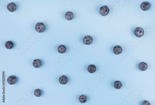 background berries of blueberries on a blue background - the concept of a healthy diet. Summer bright background, food design