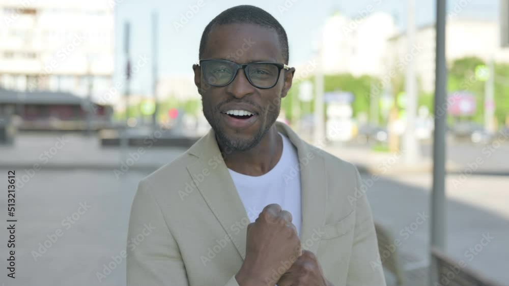 Portrait of Excited African Man Celebrating Success Outdoor Portrait of Excited African Man Celebrating Success Outdoor