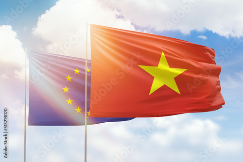 Sunny blue sky and flags of vietnam and european union