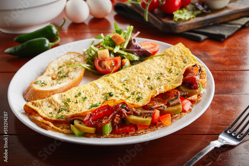mexican omelette roll with salad served in a dish isolated on wooden background side view