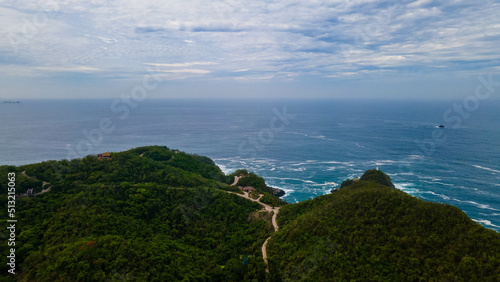 Aerial view of sea waves, mountains and sandy beach