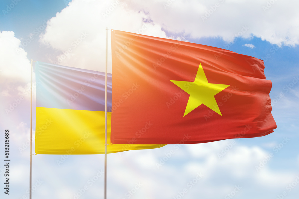 Sunny blue sky and flags of vietnam and ukraine Sunny blue sky and flags of vietnam and ukraine