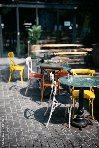 Tables and chairs at outdoor restaurant on a sunny day photo