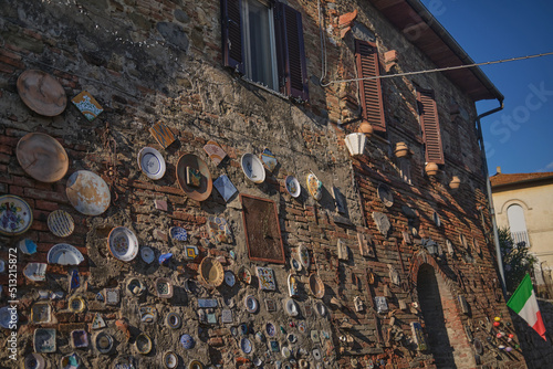 Plates on a wall in Italian village street photo