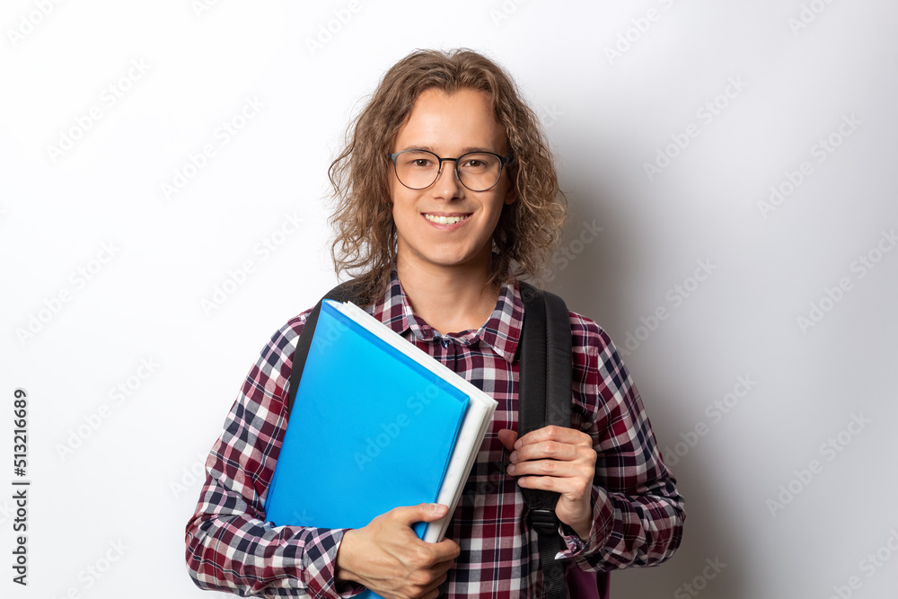 Portrait of a student with textbooks. Happy young man on a white background. Education concept. Portrait of a student with textbooks. Happy young man on a white background. Education concept.