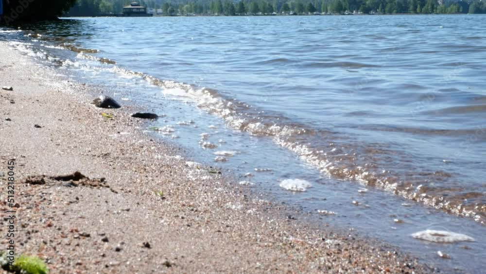 Summer landscape, waves on the lake on the sandy shore. Sunny summer day. Summer landscape, waves on the lake on the sandy shore. Sunny summer day.