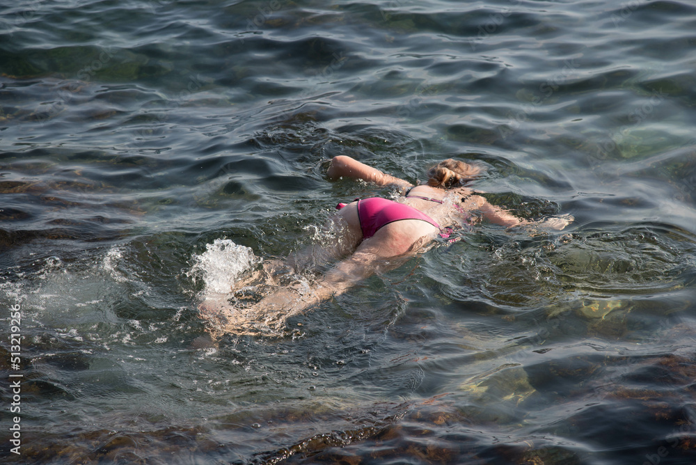 Girl dives in the black sea