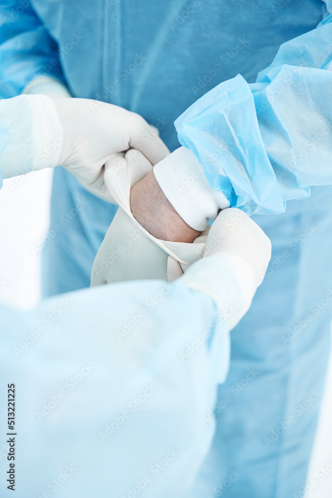 Fototapeta premium Medical workers wearing protective clothes before the operation