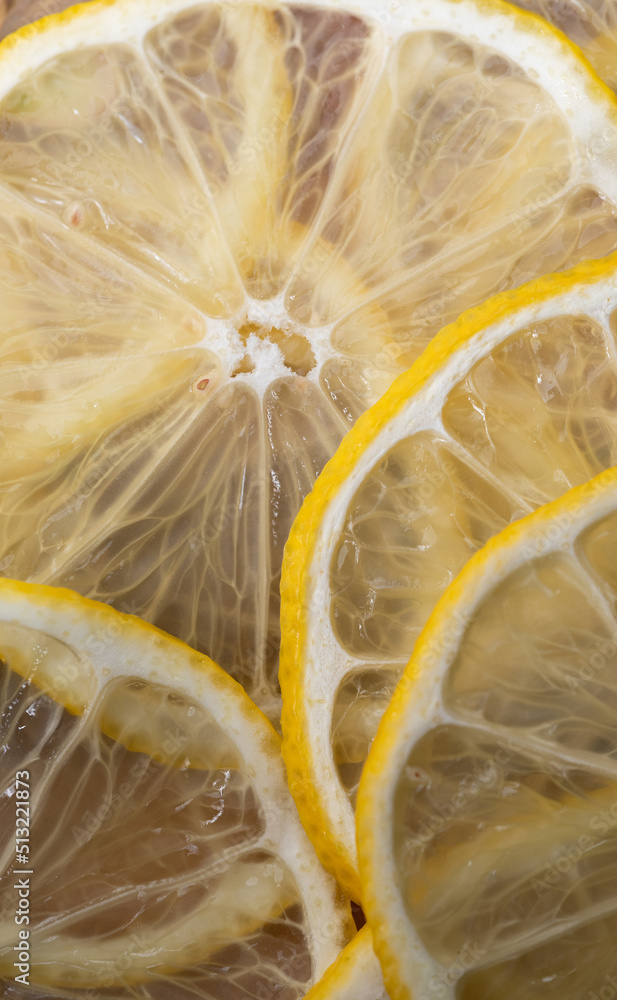 Lemon thin slices filling the entire space, stacked on top of each other. Refreshing citrus in close-up. Lemon, citrus background.