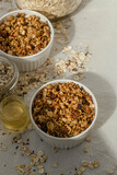 buckwheat in a bowl, jars with muesli, honey and seeds 