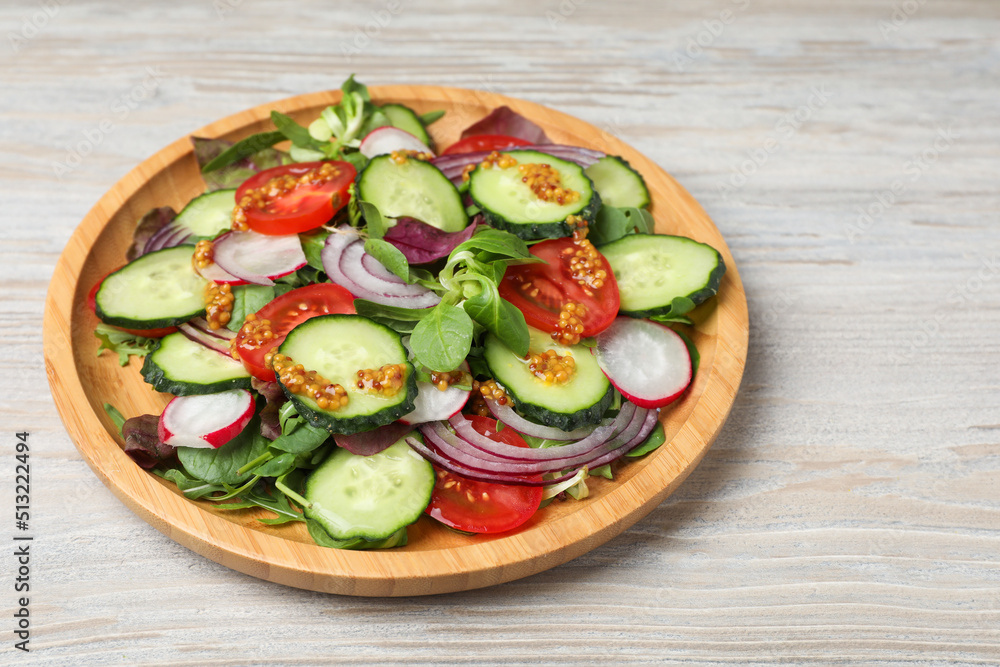 Tasty salad with different vegetables on wooden table