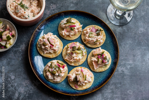 Party canapes, blinis with salmon spread photo