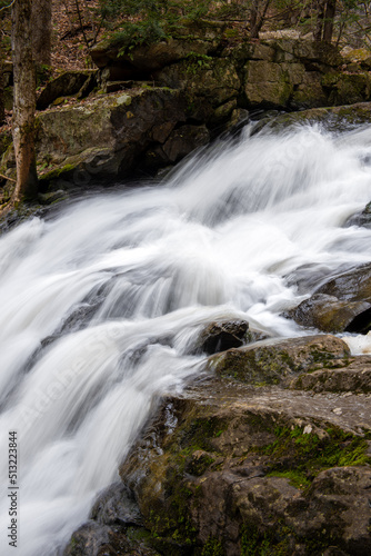 Fototapeta Naklejka Na Ścianę i Meble -  A stream cascades down over rocks.