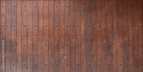Fotografie panoramic texture of a mistreated varnished wood wooden fence surface with metal