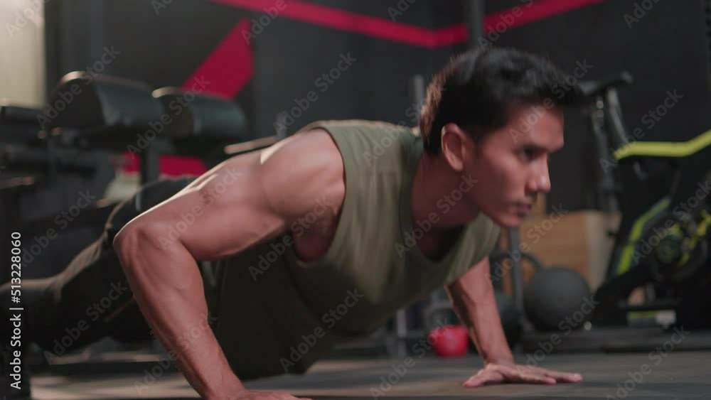Sport fitness indoor, Handsome young asian athletic man doing push up exercise muscular. Muscular guy strong in sportswear bodybuilding training doing pushup workout on floor at crossfit gym. Sport fitness indoor, Handsome young asian athletic man doing push up exercise muscular. Muscular guy strong in sportswear bodybuilding training doing pushup workout on floor at crossfit gym.