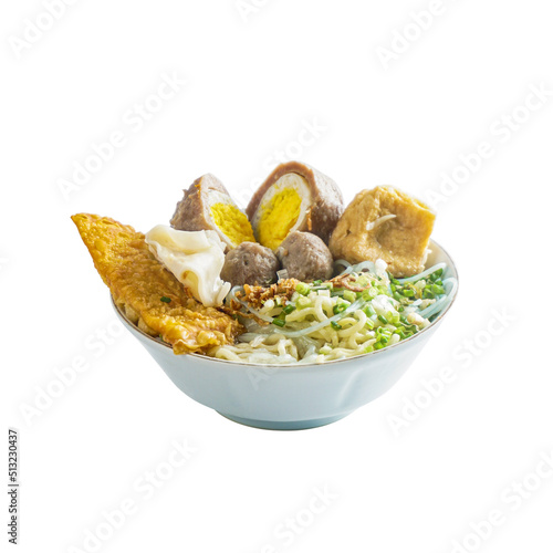 Hot traditional indonesian meatballs bakso with eggs, noodles, vegetables and gravy broth photo