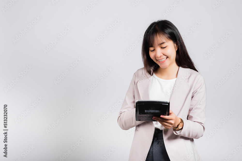 Tax day concept. Woman confident smiling holding electronic calculator, Portrait excited happy Asian young female studio shot isolated on white background, Business Account and finance counting income Tax day concept. Woman confident smiling holding electronic calculator, Portrait excited happy Asian young female studio shot isolated on white background, Business Account and finance counting income