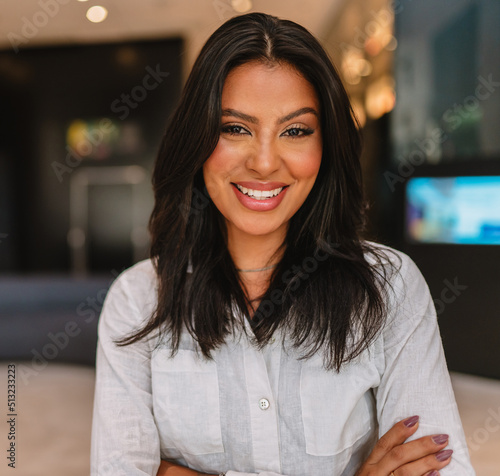 Smiling Latin businesswoman at hotel lobby. photo
