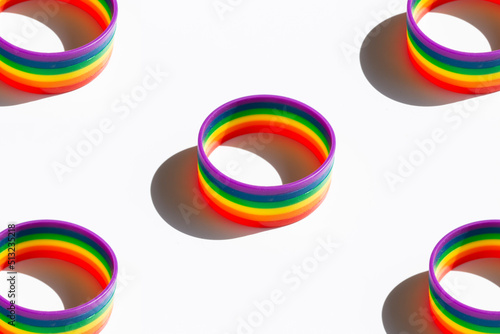 Pride rainbow awareness wristbands on white background.