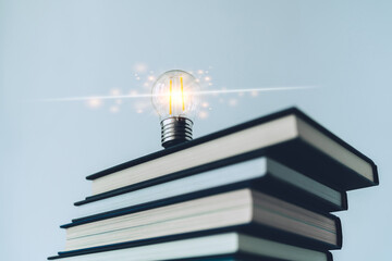 Glowing lightbulb or bright lamp with book or textbook. Skill improvement for student or businessperson. Studying and training course online at home. Business success idea, education learning concept