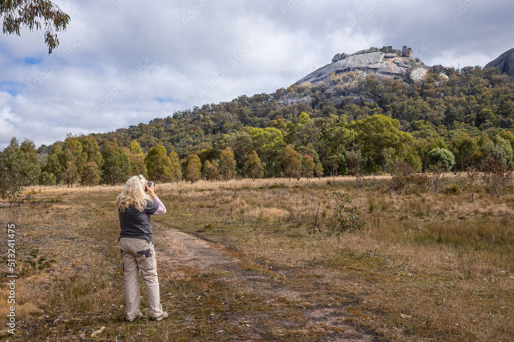 Woman Taking Photographs of Granite Outcrop Woman Taking Photographs of Granite Outcrop