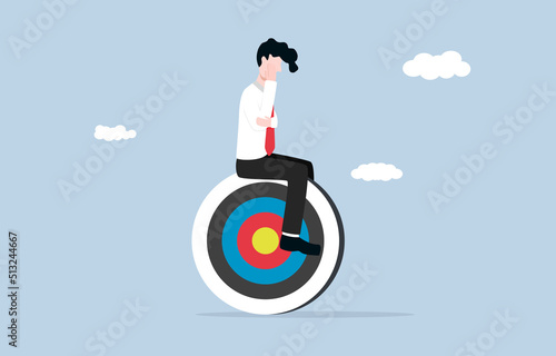 Seeking propose of life, finding passion at work, 
contemplation to achieve business goal, rational thinking concept. Contemplative businessman sitting on archery target. 
