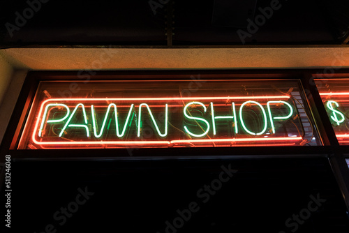 Quadro su tela Pawn shop sign glowing from a dark window