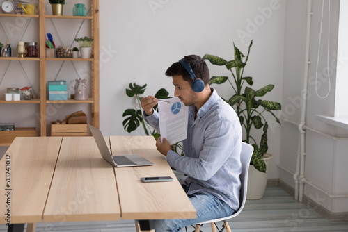 Businessman in headphone use laptop lead virtual briefing, make sales statistics analysis, explain infographic, participate in business meeting with client. Videocall, workflow use modern tech concept