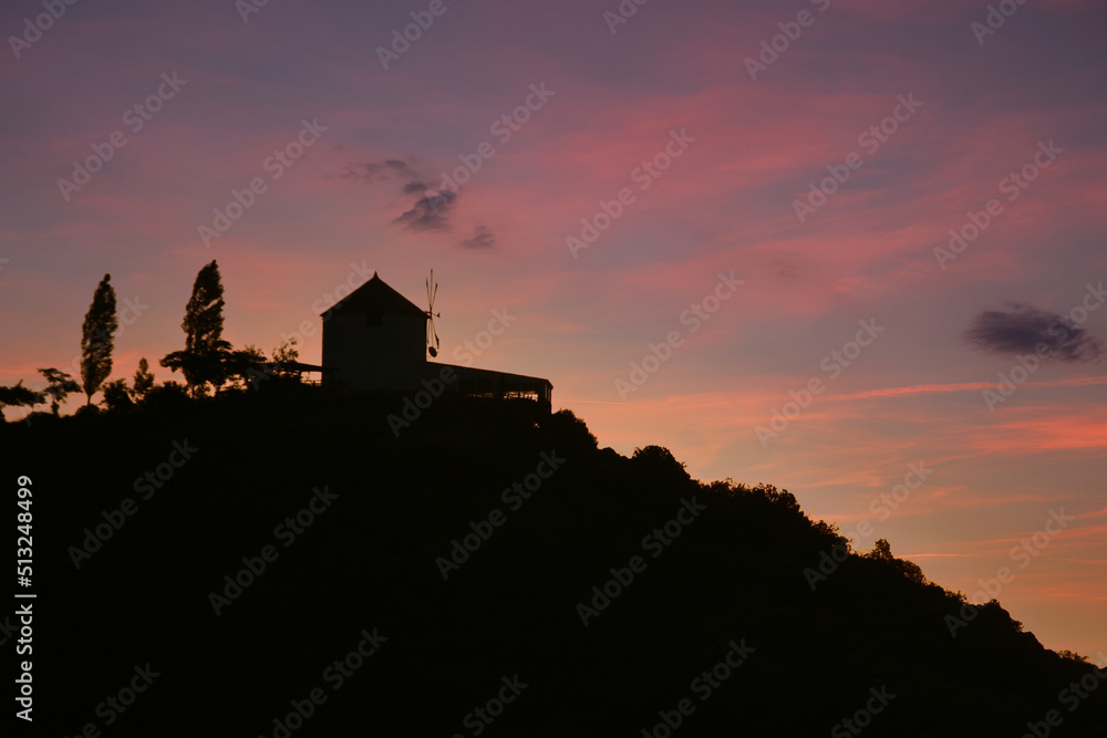 Old mill on a hill at sunset in Greece Old mill on a hill at sunset in Greece