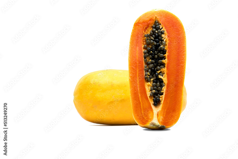 Whole and half of ripe papaya fruit with seeds isolated on white