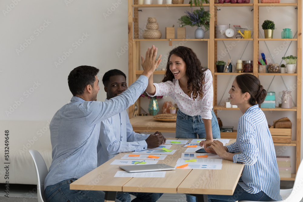 Four Enthusiastic Multiethnic Staff Members Gather In Office Board Room four-enthusiastic-multiethnic-staff-members-gather-in-office-board-room