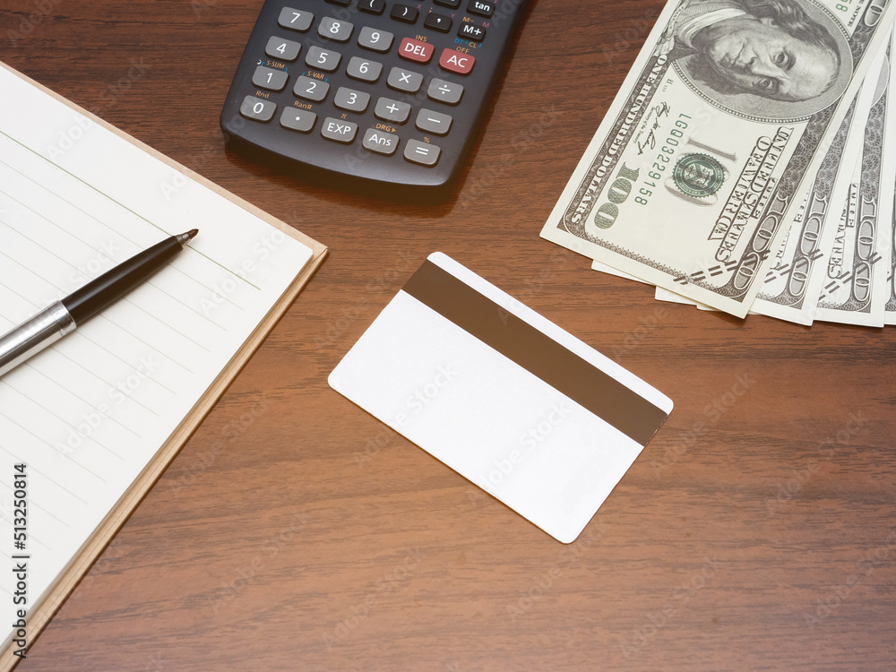 Credit card with calculator workspace and money on table top view Credit card with calculator workspace and money on table top view