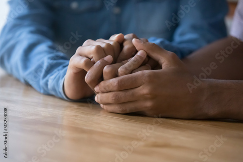 Close up African couple holding hands, demonstrate support, express trust, say sorry. Family reconciliation, understanding in relationships, feelings, love, confidential conversation, apology concept