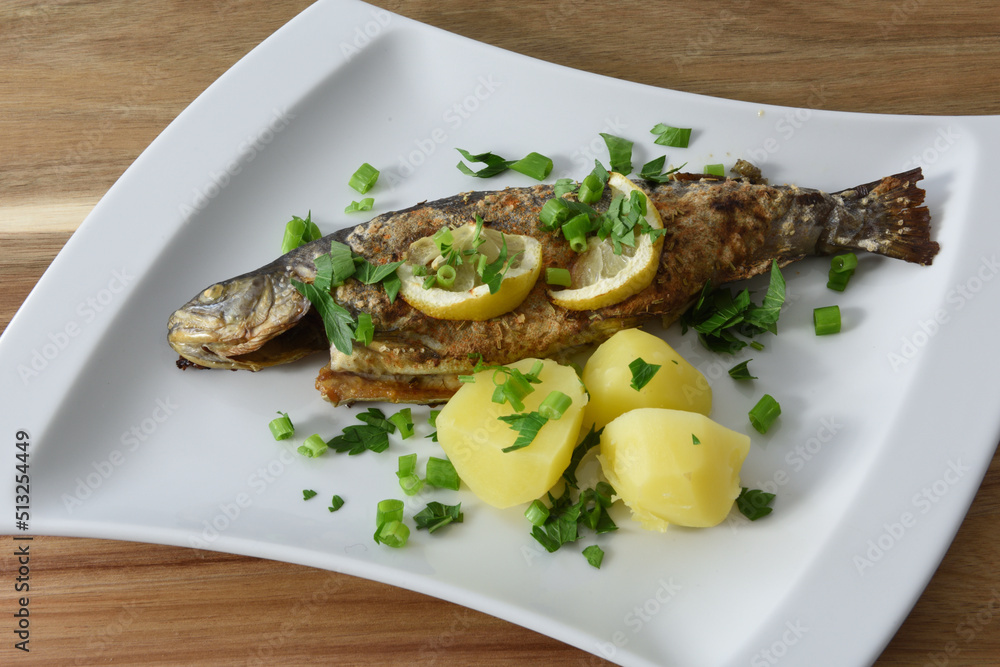 gebratene Forelle mit Petersilienkartoffeln und Zitronen foto de Stock ...