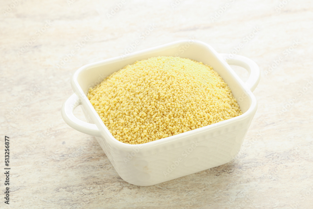 Raw couscous in the bowl Raw couscous in the bowl