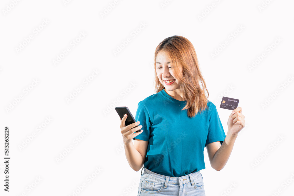 Asian woman holding credit card and smartphone on white background Asian woman holding credit card and smartphone on white background