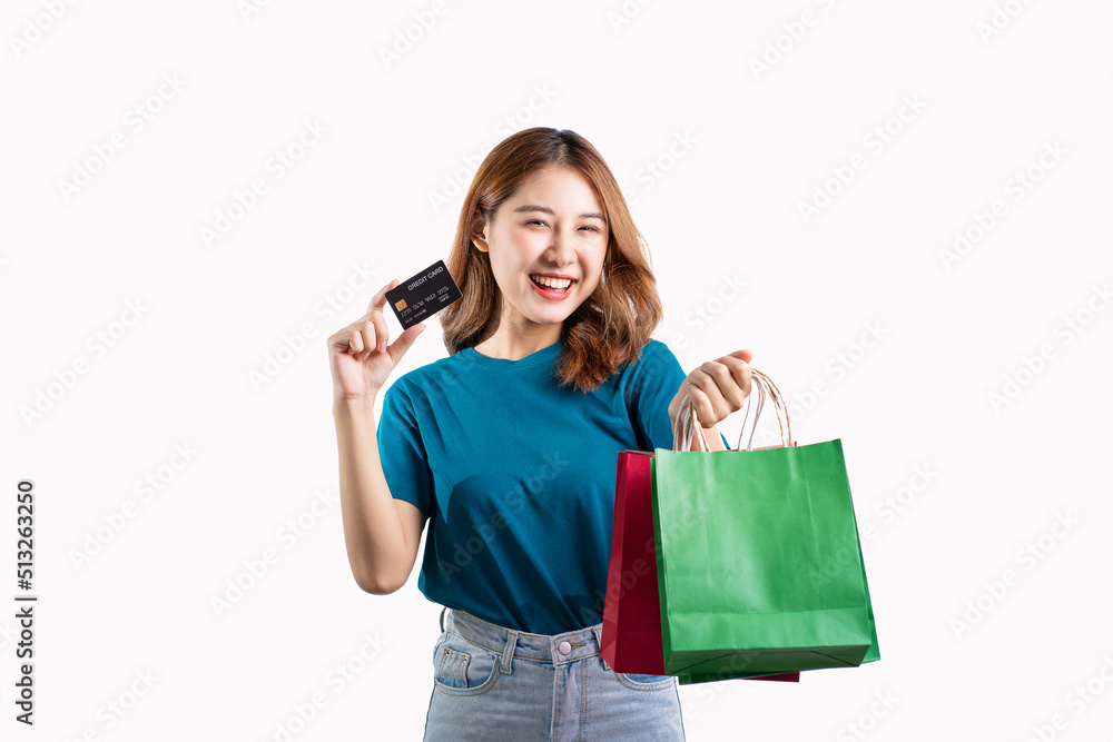 Asian woman holding shopping bag with credit card on white background Asian woman holding shopping bag with credit card on white background
