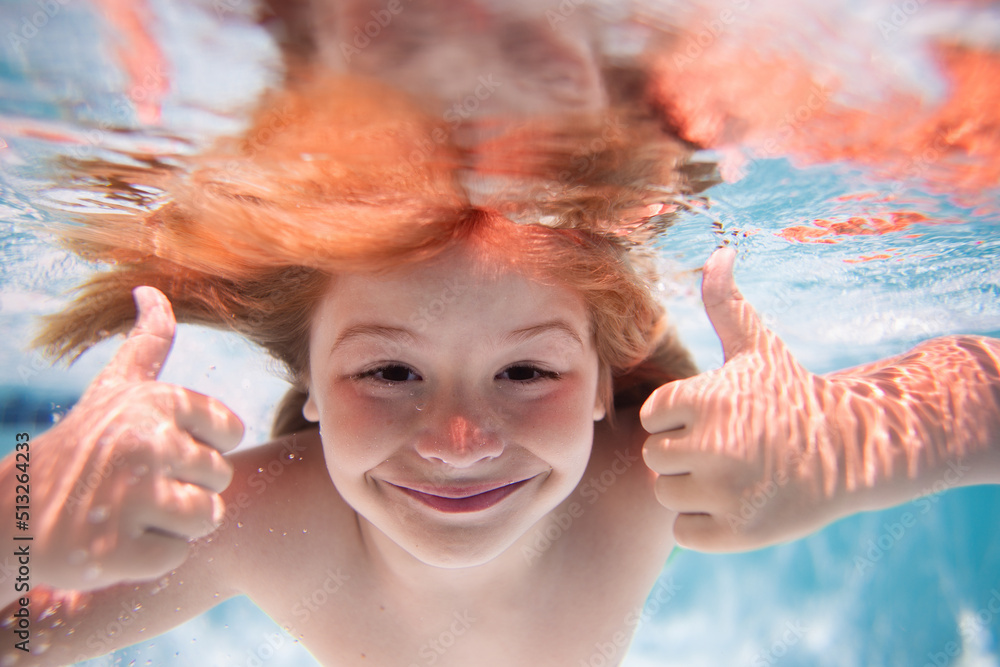 Funny excited kids face under water. Underwater. Child in the swimming