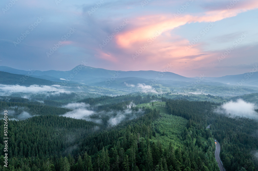 Aerial view of green mountains at sunset