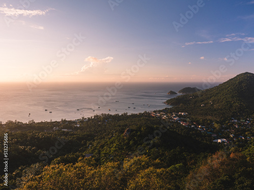 Scenic high angle view of sunset orange sky and Sairee beach in the peaceful evening with faraway Koh Nang Yuan Island. Shot from West Coast Viewpoint. Koh Tao Island, Surat Thani, Thailand.