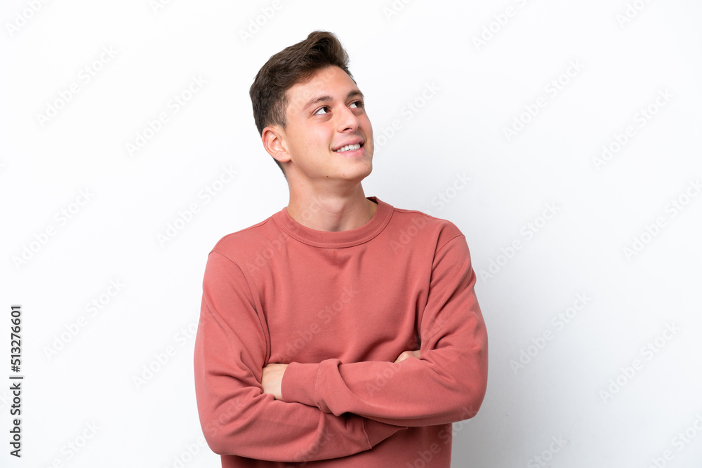 Young handsome Brazilian man isolated on white background looking up while smiling Young handsome Brazilian man isolated on white background looking up while smiling